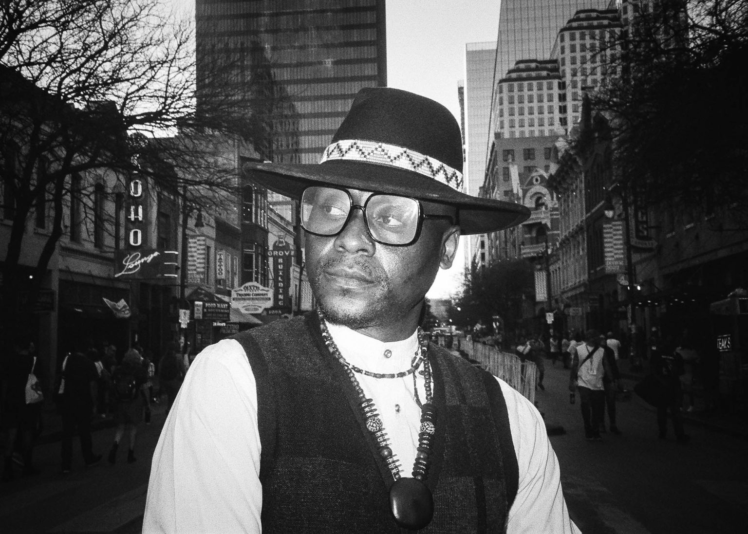 Portrait with hat and glasses on Sixth Street in Austin,TX