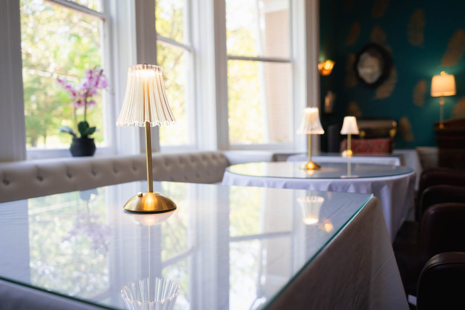 Lamps on tables in dining room at hotel