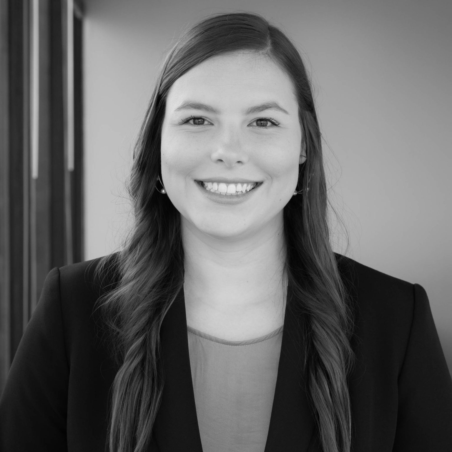 Smiling lawyer headshot photo in her office