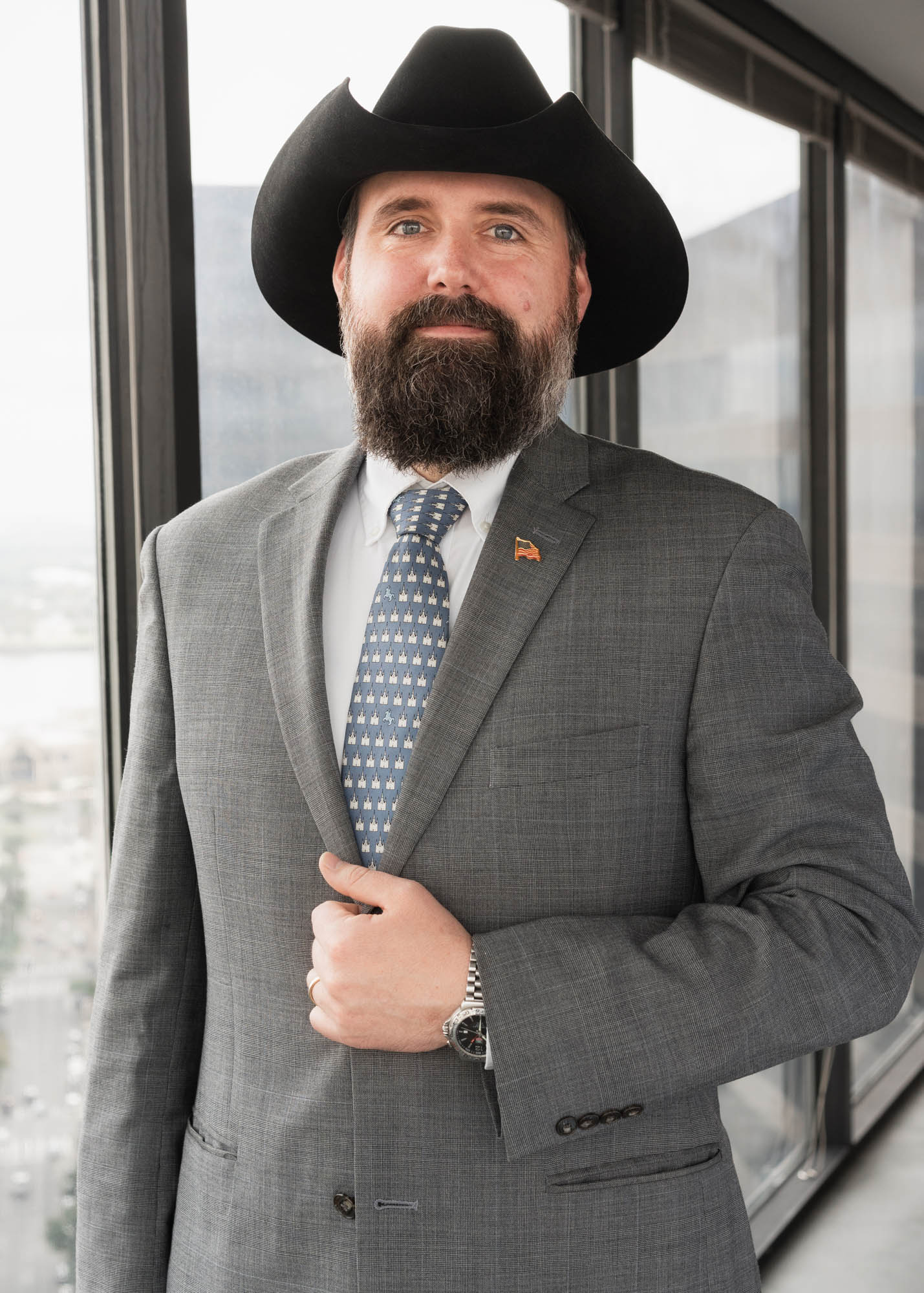 Attorney posing wearing a cowboy hat in his NOLA office