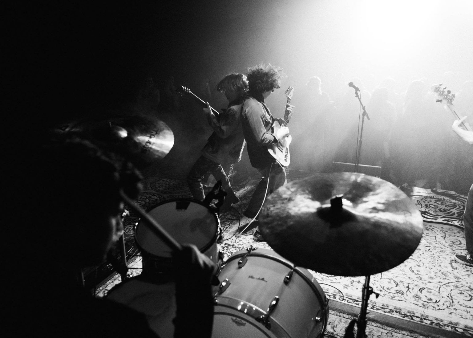 Lead guitarist and singer playing their instruments back to back on stage at Mid City Ballroom in Baton Rouge