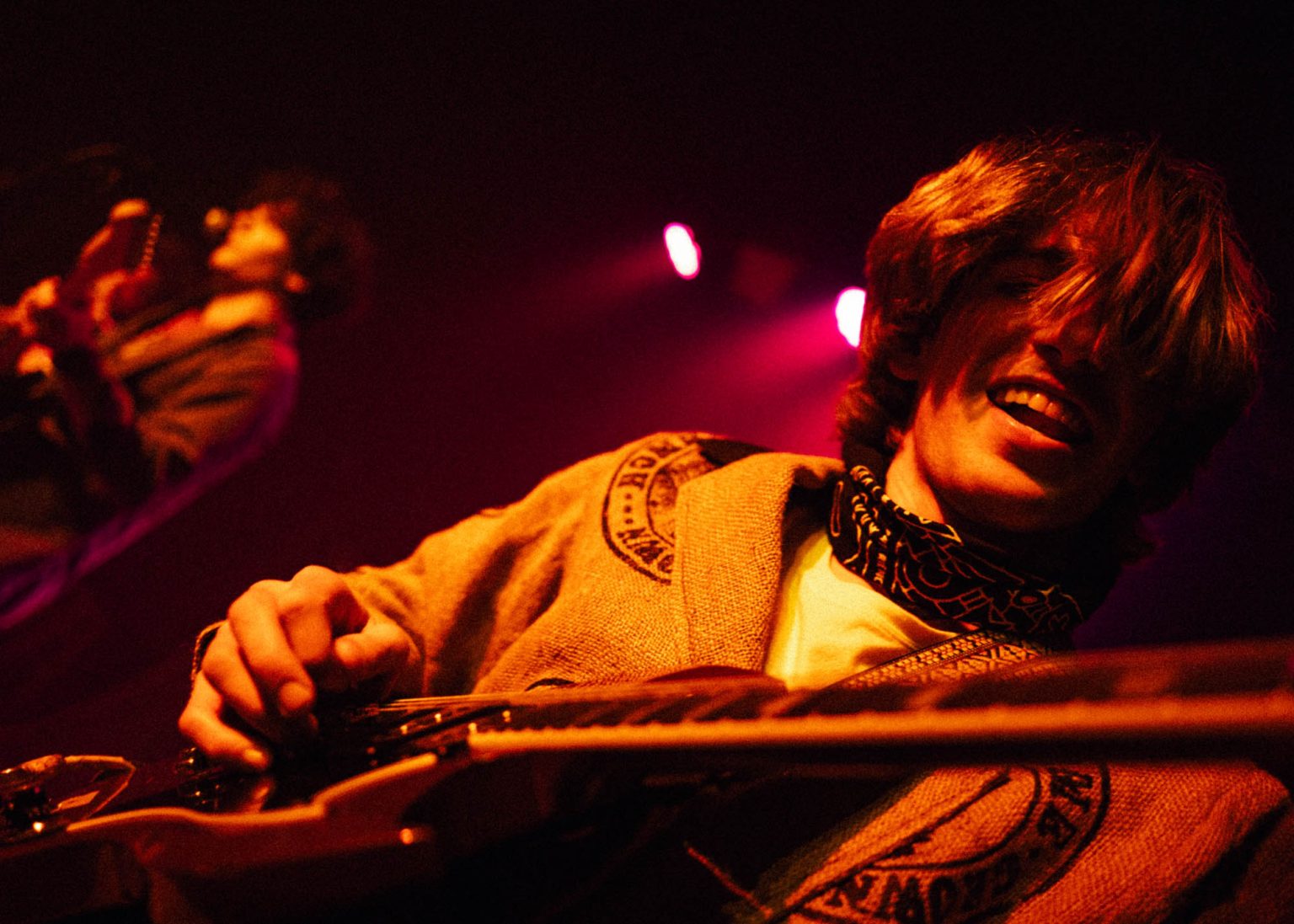 Lead guitarist smiling while play his guitar