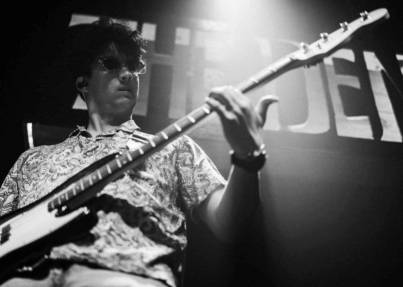 Playing his bass with sunglasses live on stage at The Howlin' Wolf in New Orleans