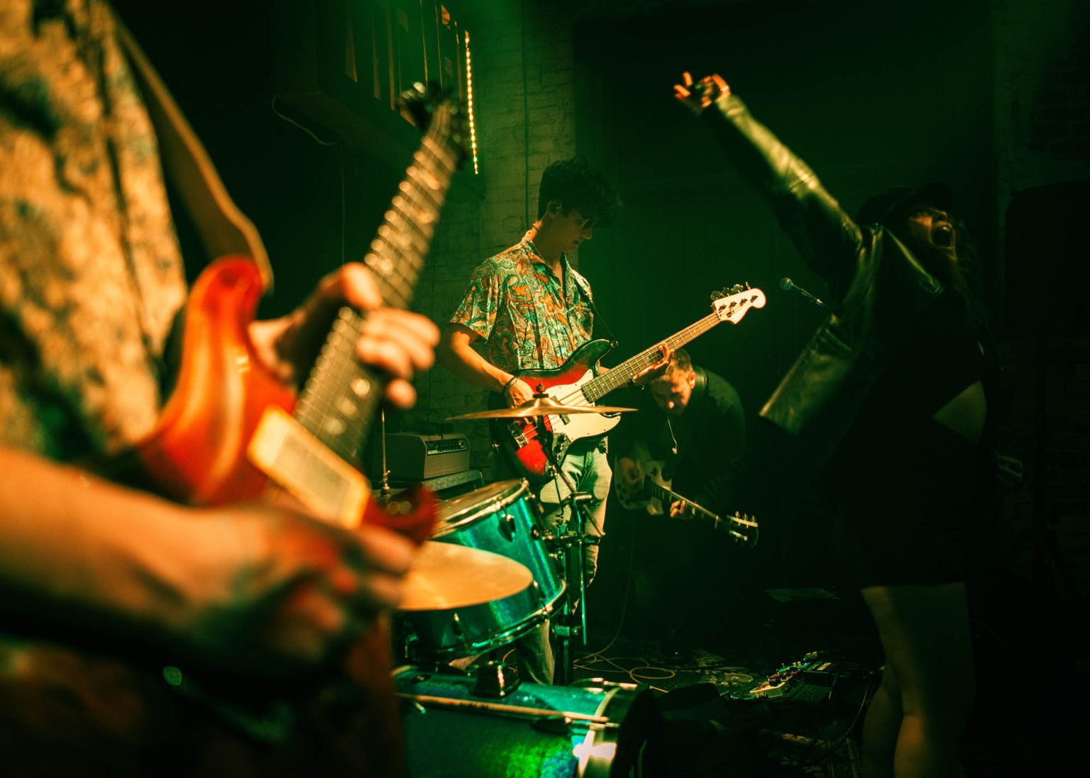 Members of Few Blue band performing on stage in Nola