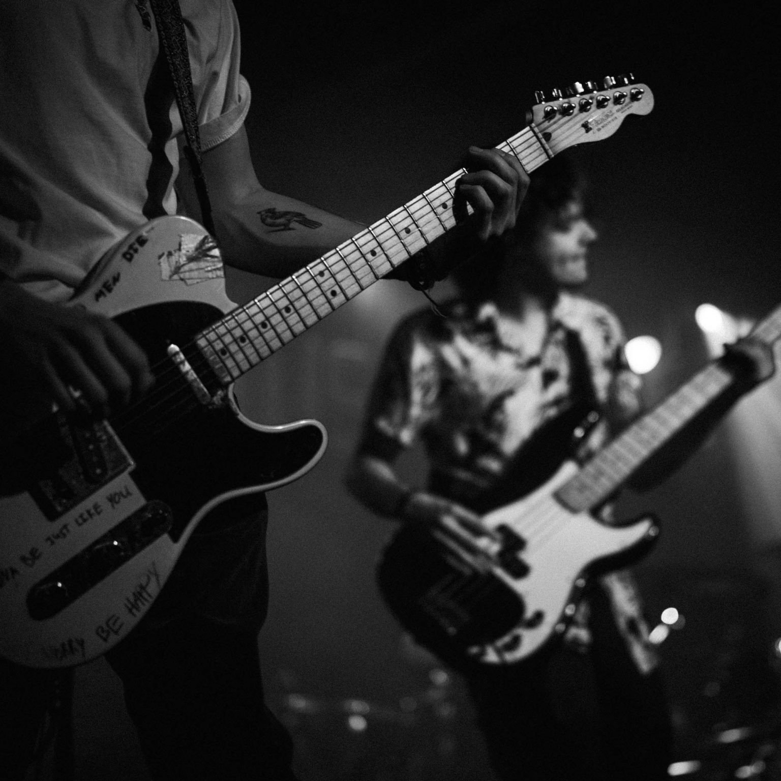 Guitarist and bassist playing music on stage