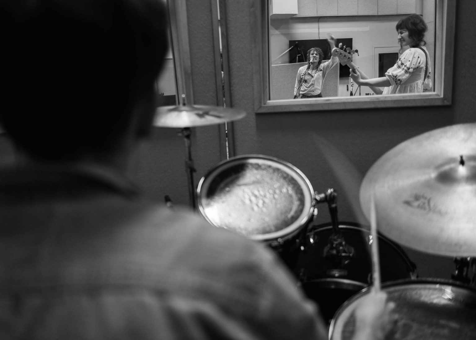 Drummer, bassist, and Maxwell Landry singing in studio