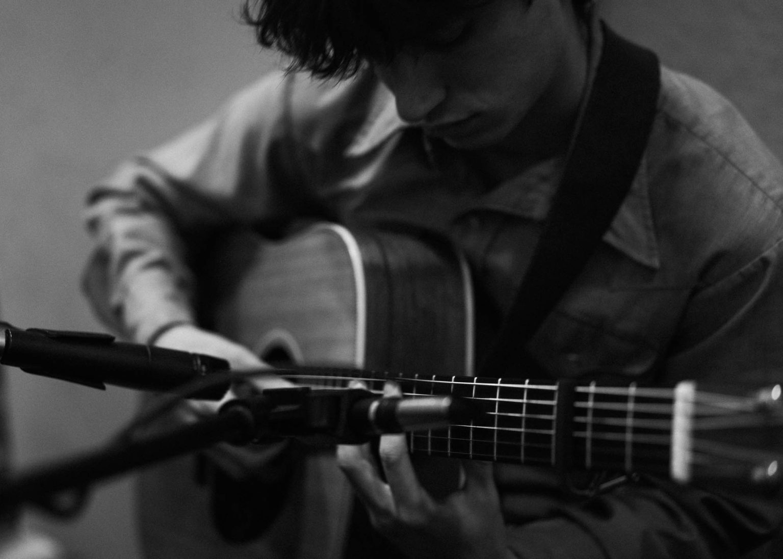 Noah Rozzell recording guitar in studio