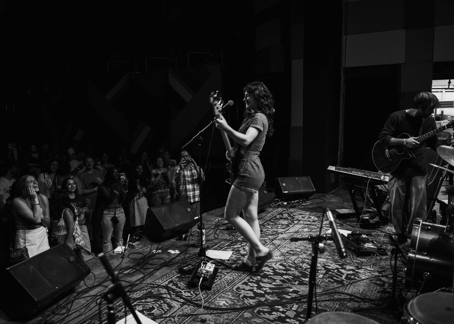 Cammy Kurtzman walking on the stage to play her guitar