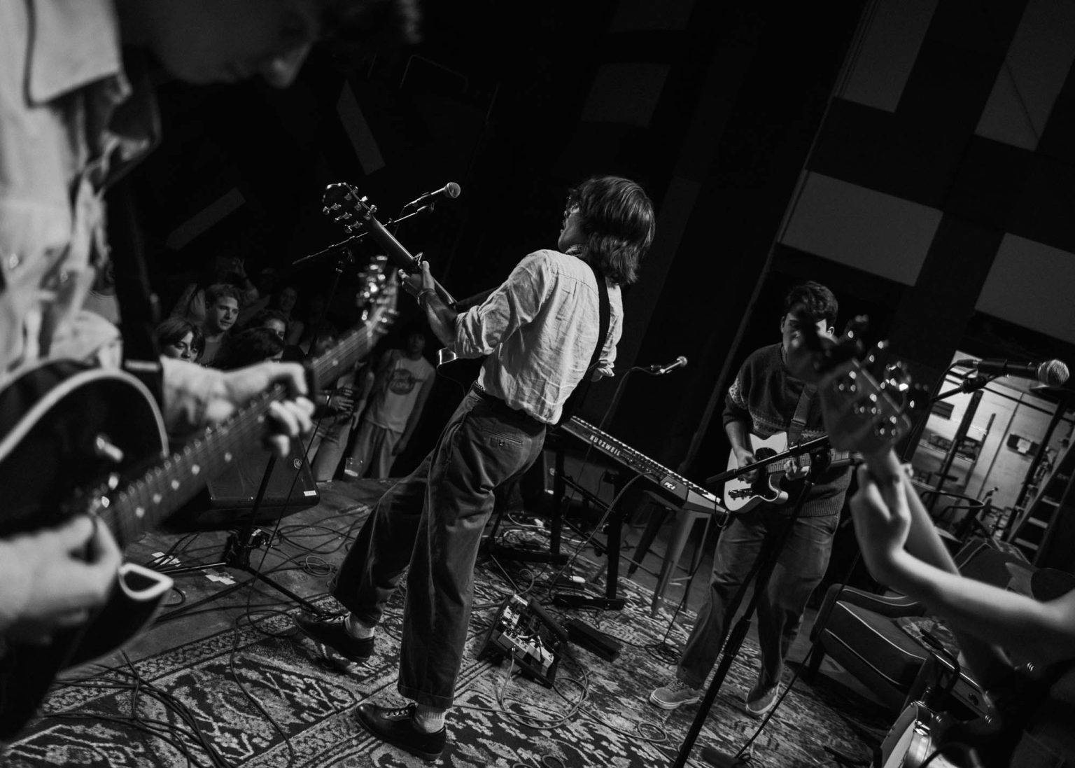 Maxwell Landry dancing on stage with his band mates