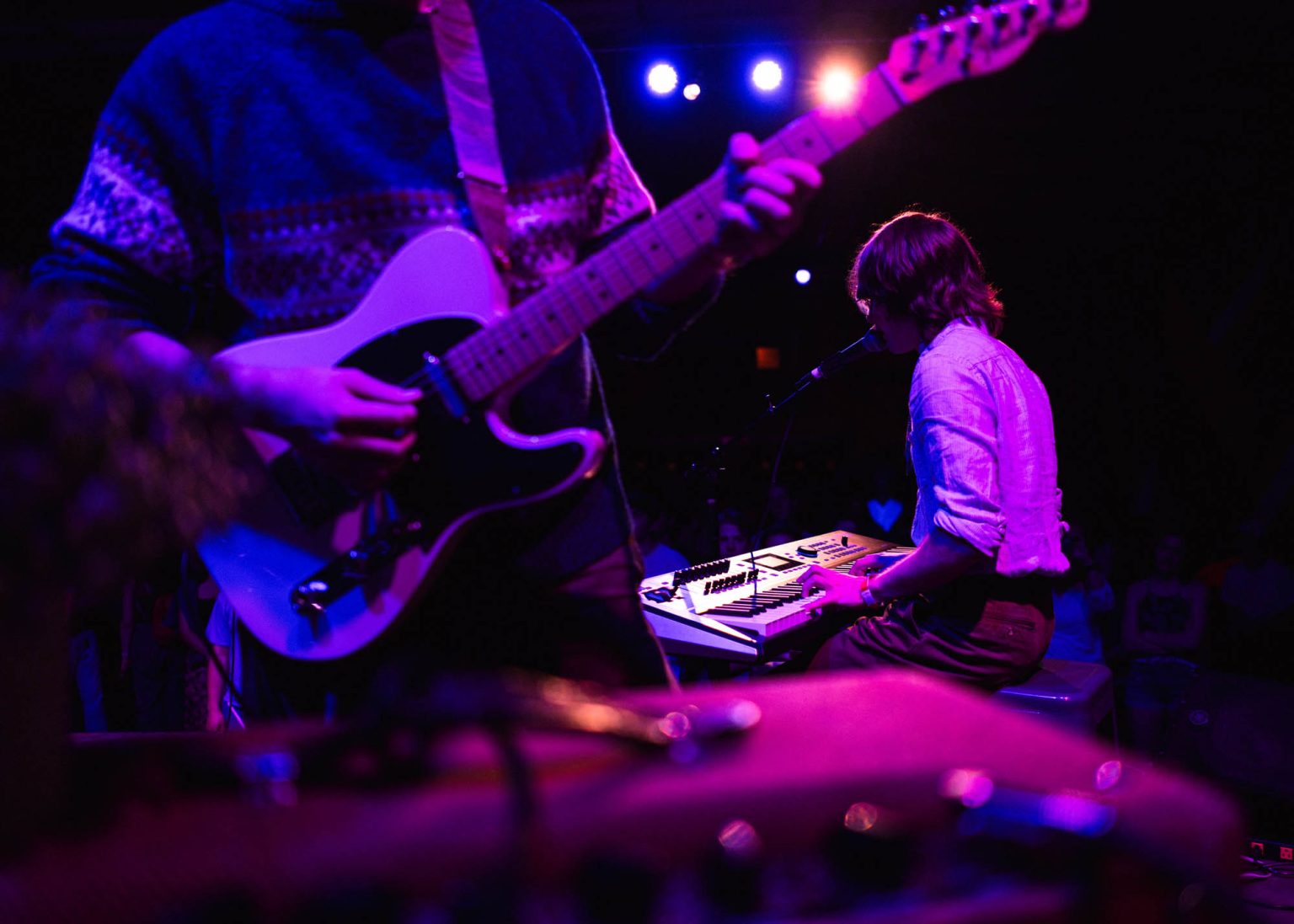 Maxwell Landry Band playing guitar and piano live on stage