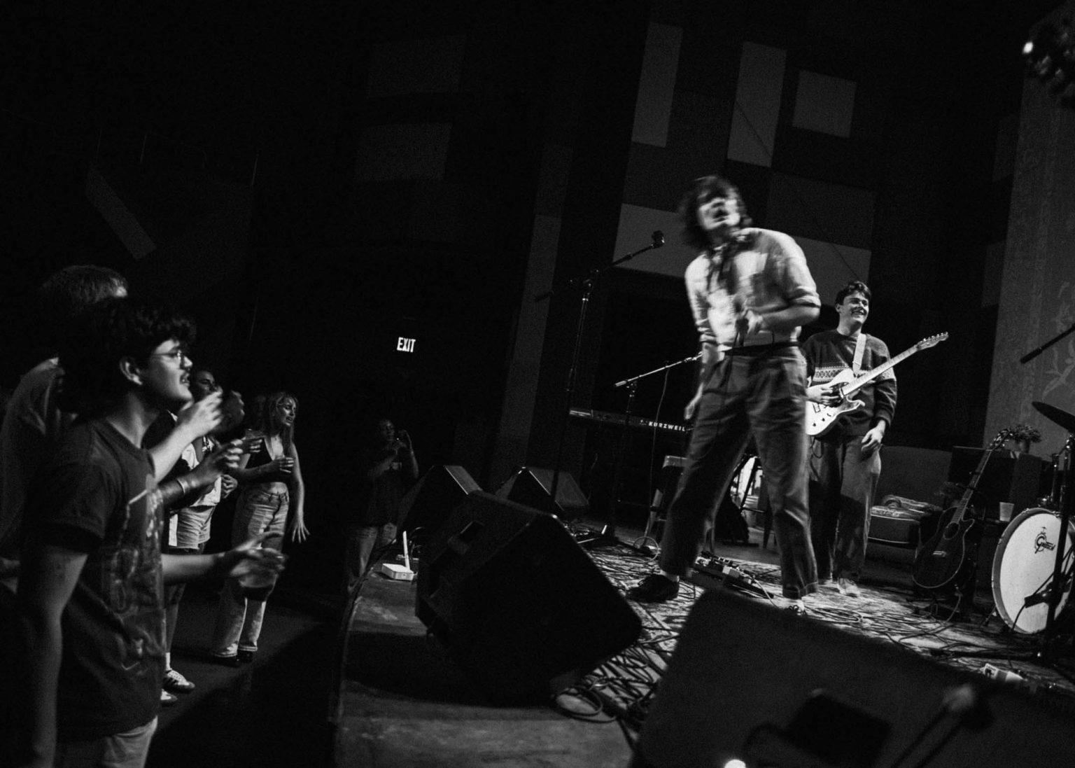 Maxwell Landry dancing with crowd while band plays their instruments