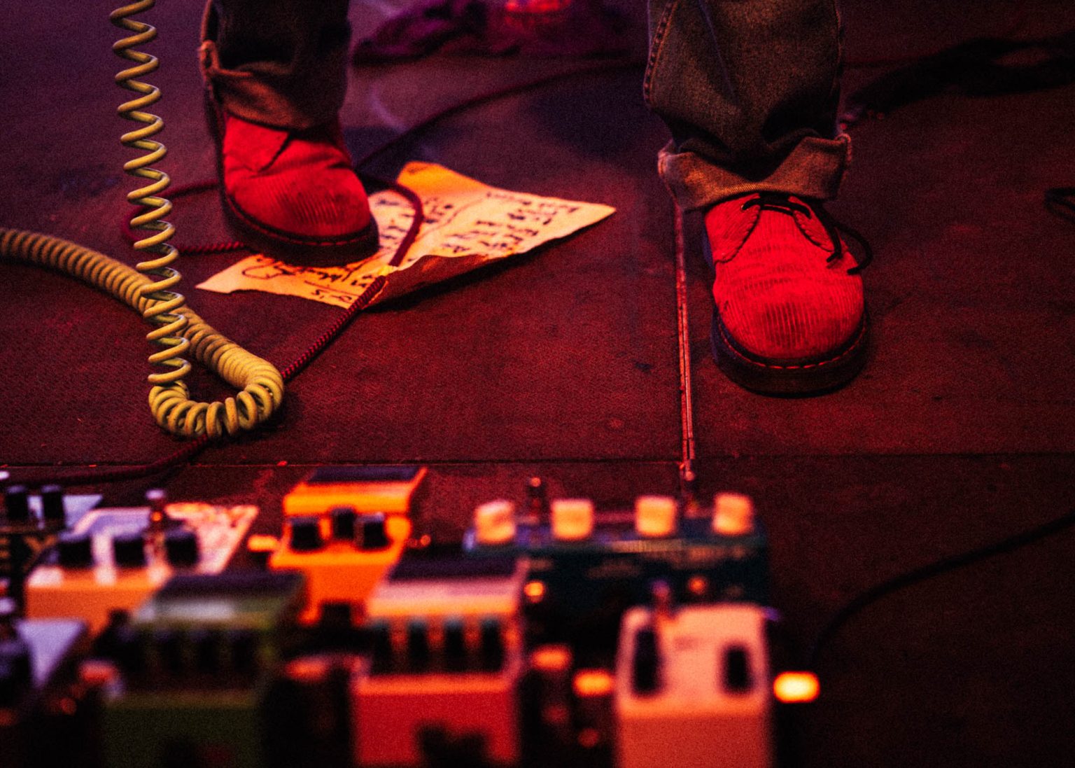 Red shoes on stage worn by the lead guitarist