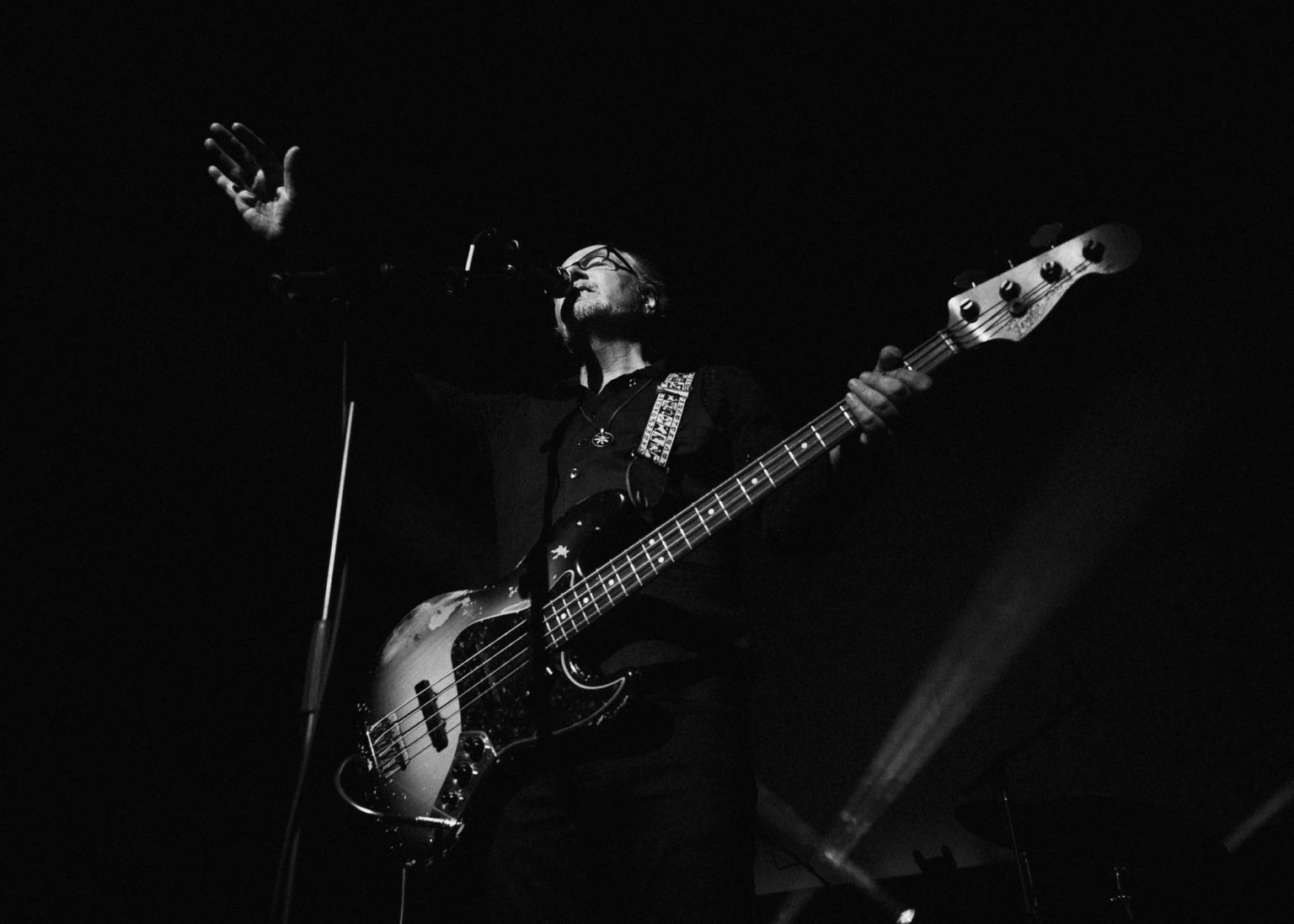 Lead singer of The Church Band singing on stage with his hand raised