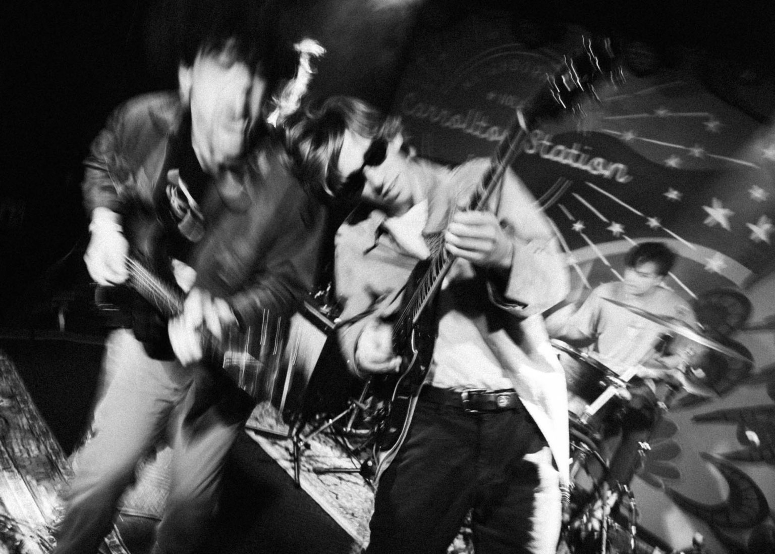 The lead singer and lead guitarist playing a song in New Orleans venue