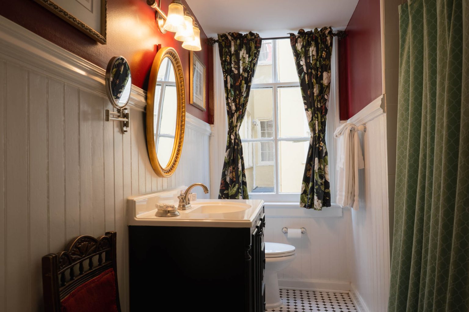 Small bathroom with vanity sink and window at Park View Historic Hotel