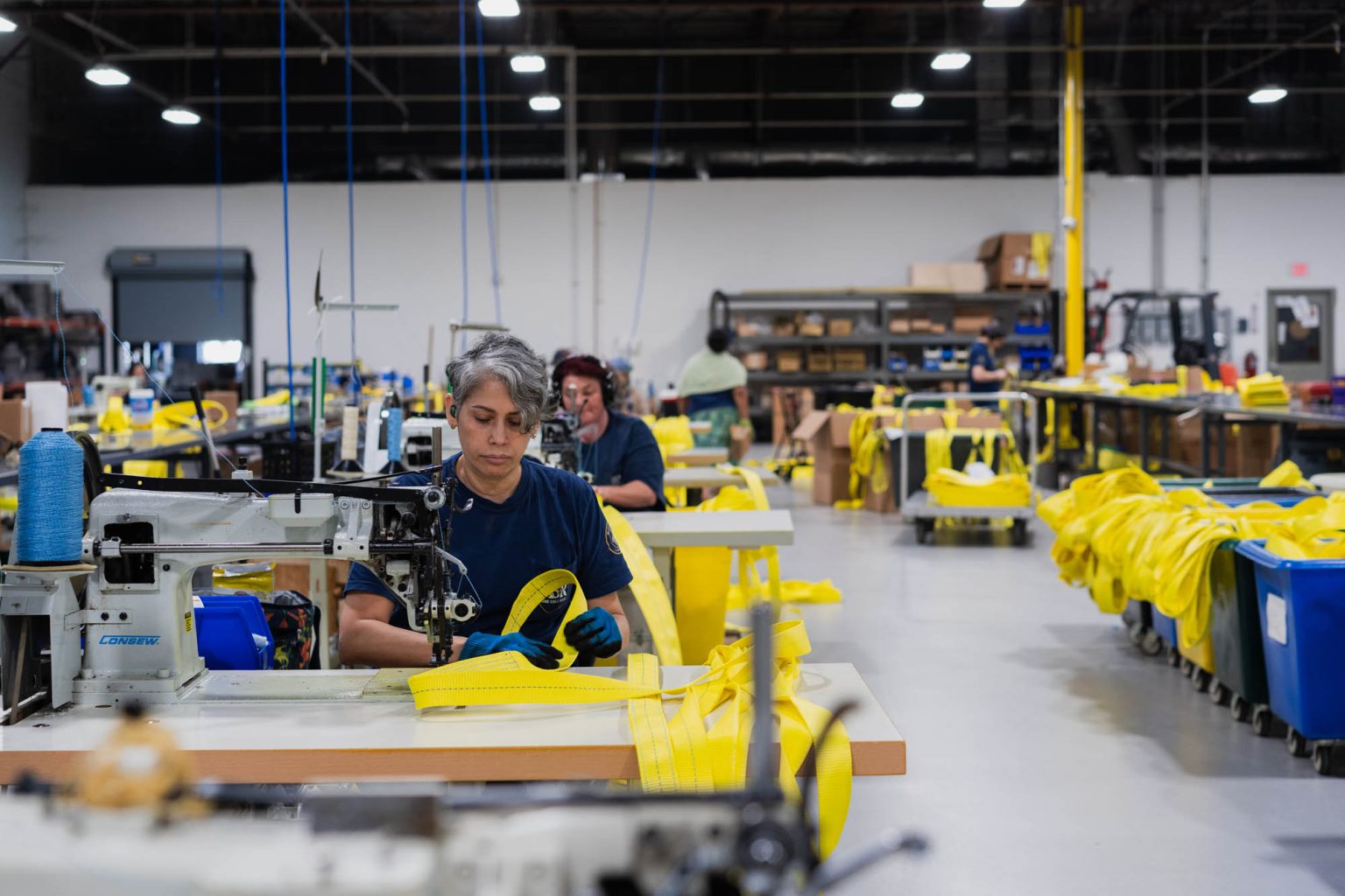 Team at work sewing products in large facility