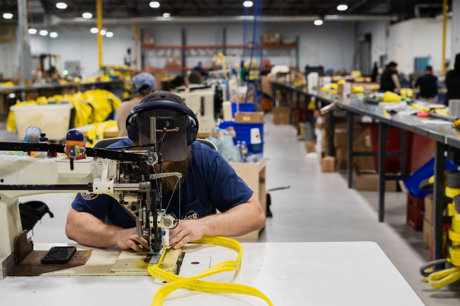 Team working the sewing machines in large well-lit facility