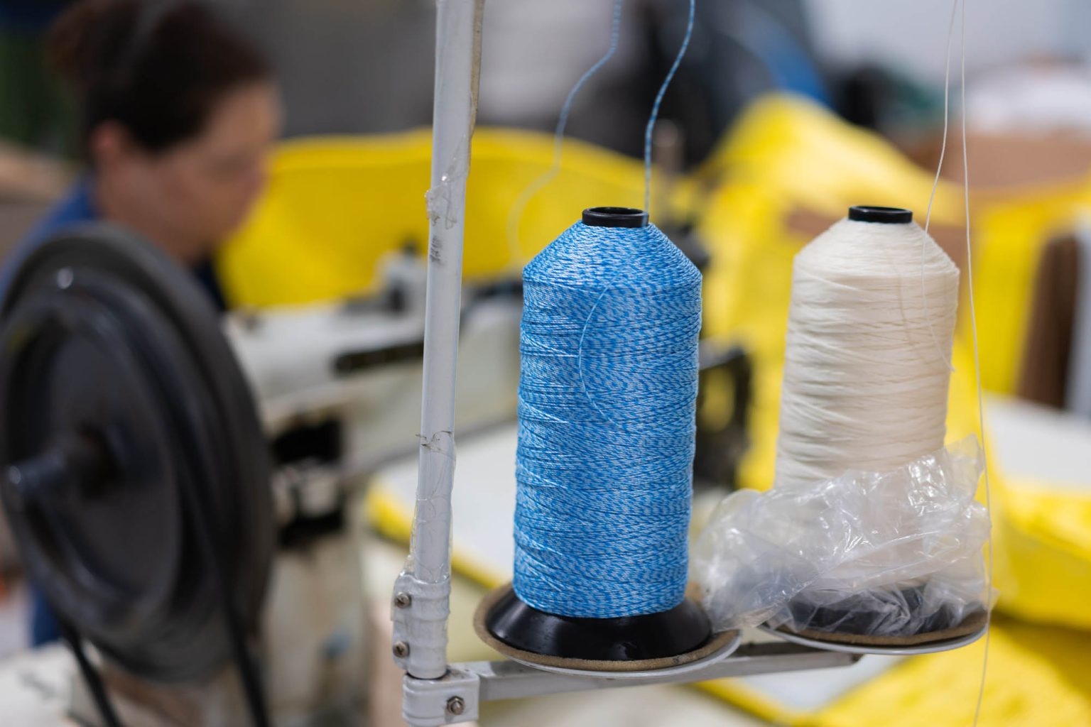 Using blue and white thread at the sewing machine