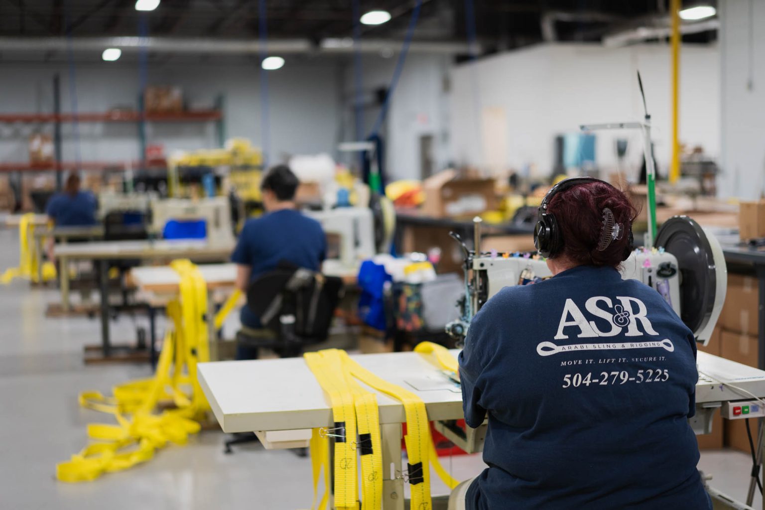 Team at work in facility headquarters crafting slings for shipment