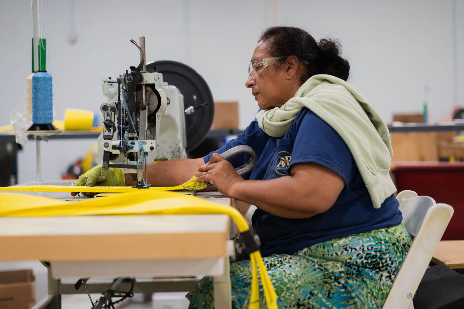 Working on creating yellow slings at the sewing machine