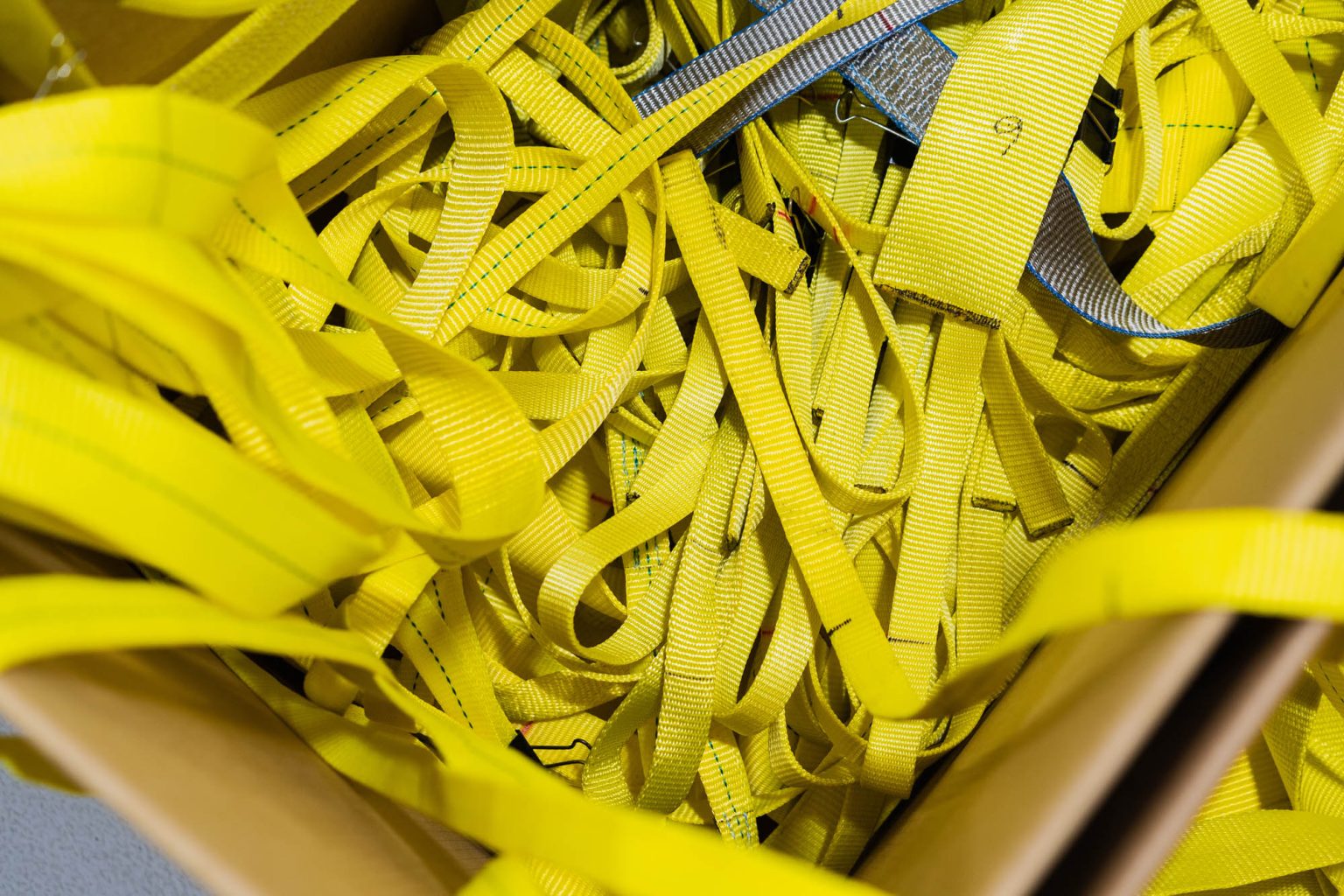 Inside of cardboard box filled with flat web sling material