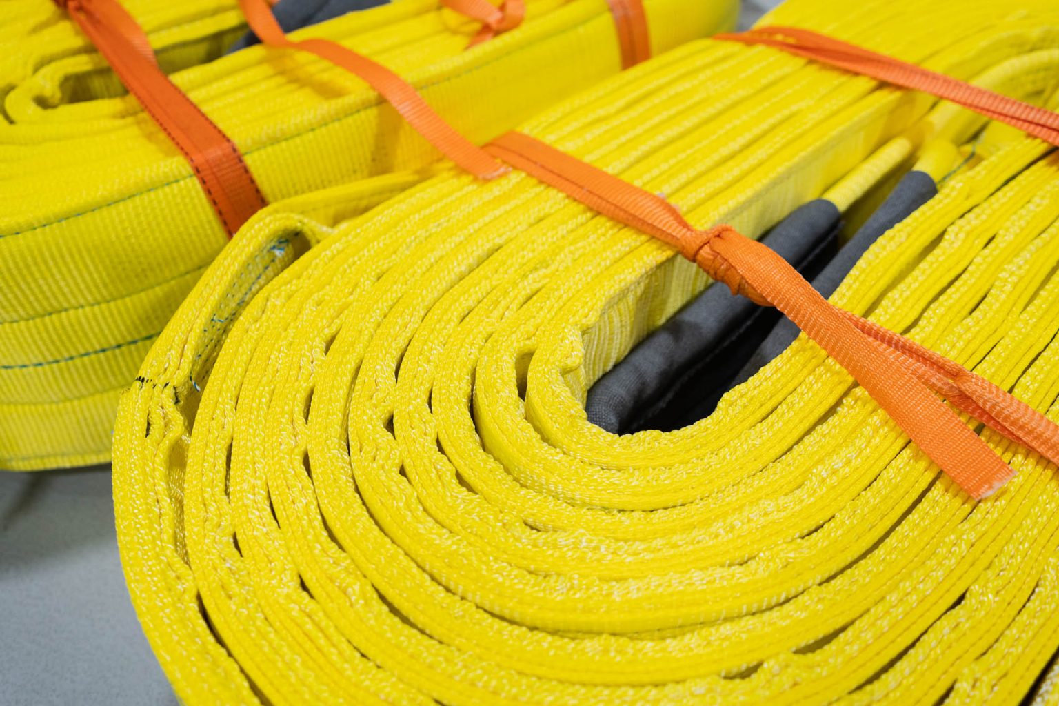 Two large sling held together with orange rope