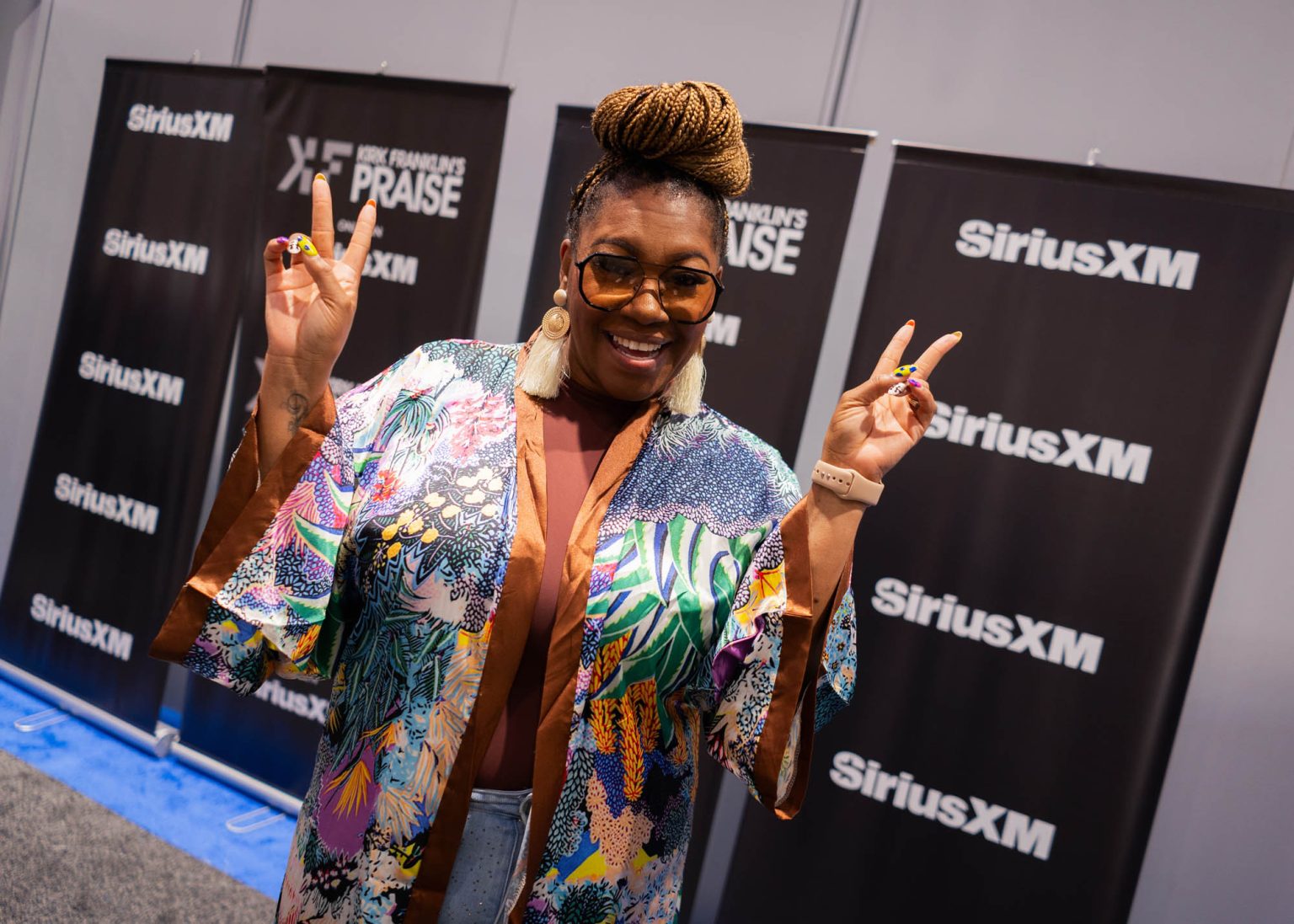 Peace signs and smiling for a portrait back stage before her performance