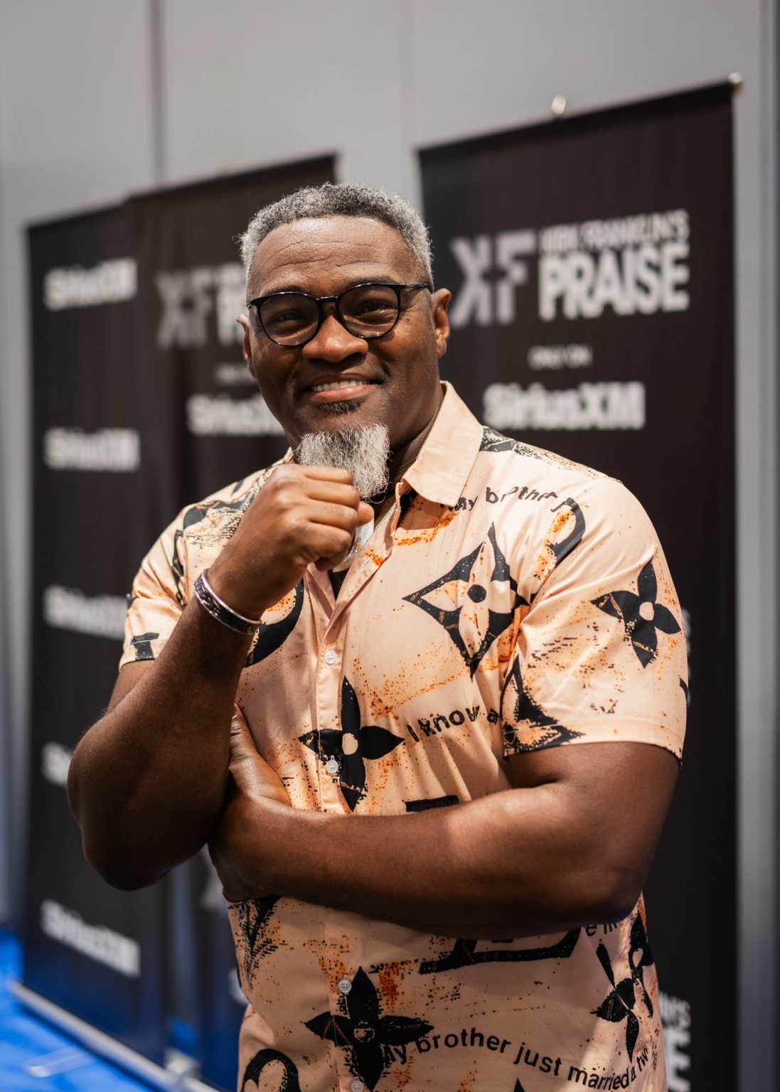 Hand on chin and smiling for a portrait back stage at the Essence Festival