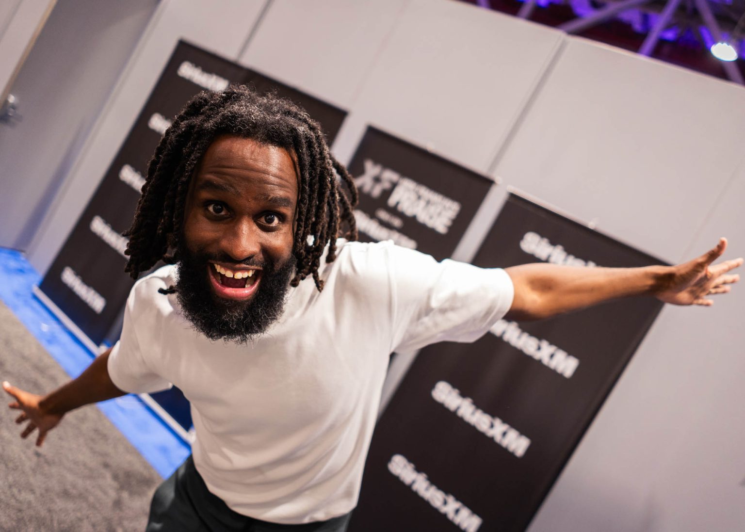 Arms stretched out posing for a back stage portrait during an event at the convention center