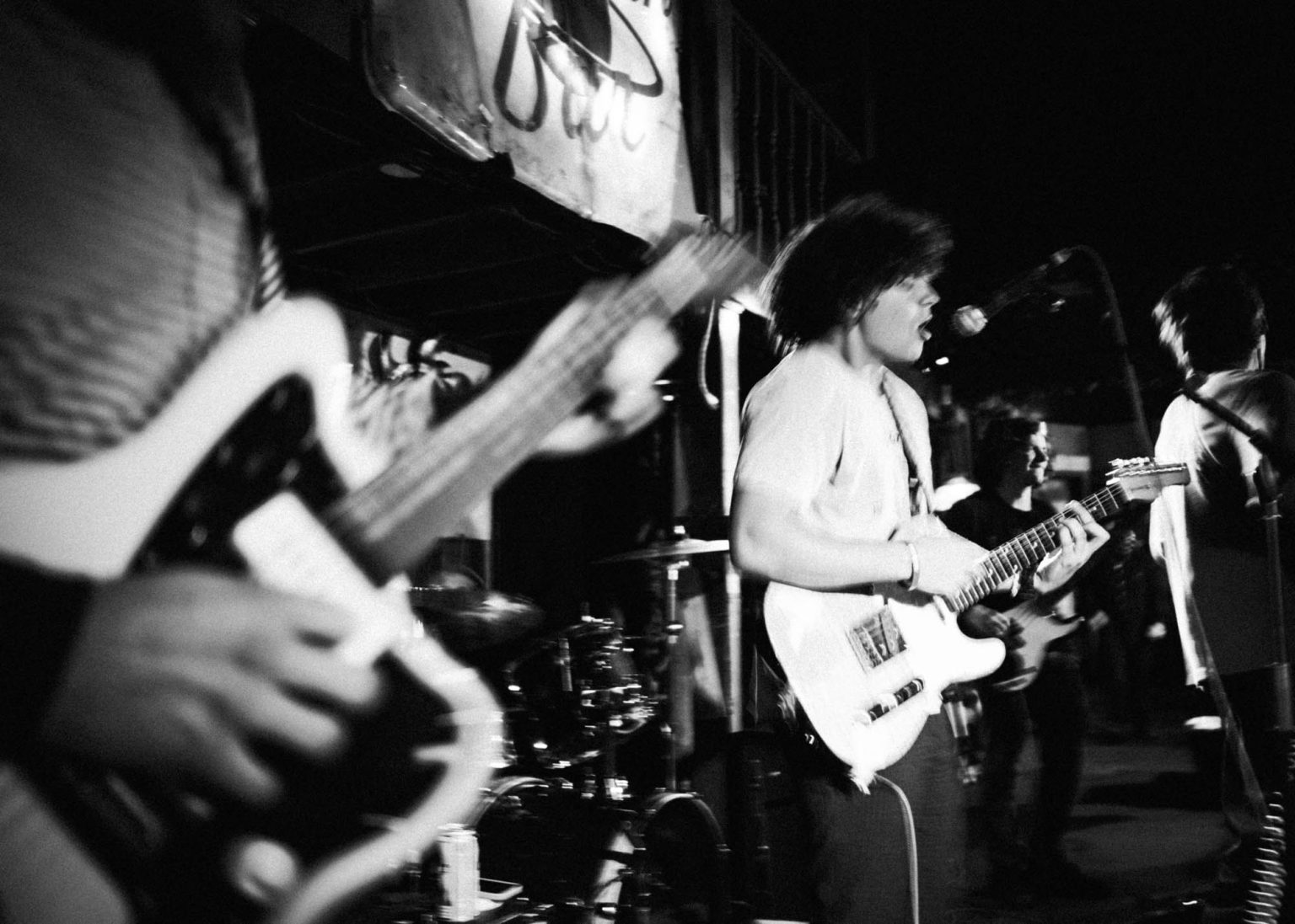 Band on stage during their live show at Saturn Bar including lead singer, guitarists, and bassist