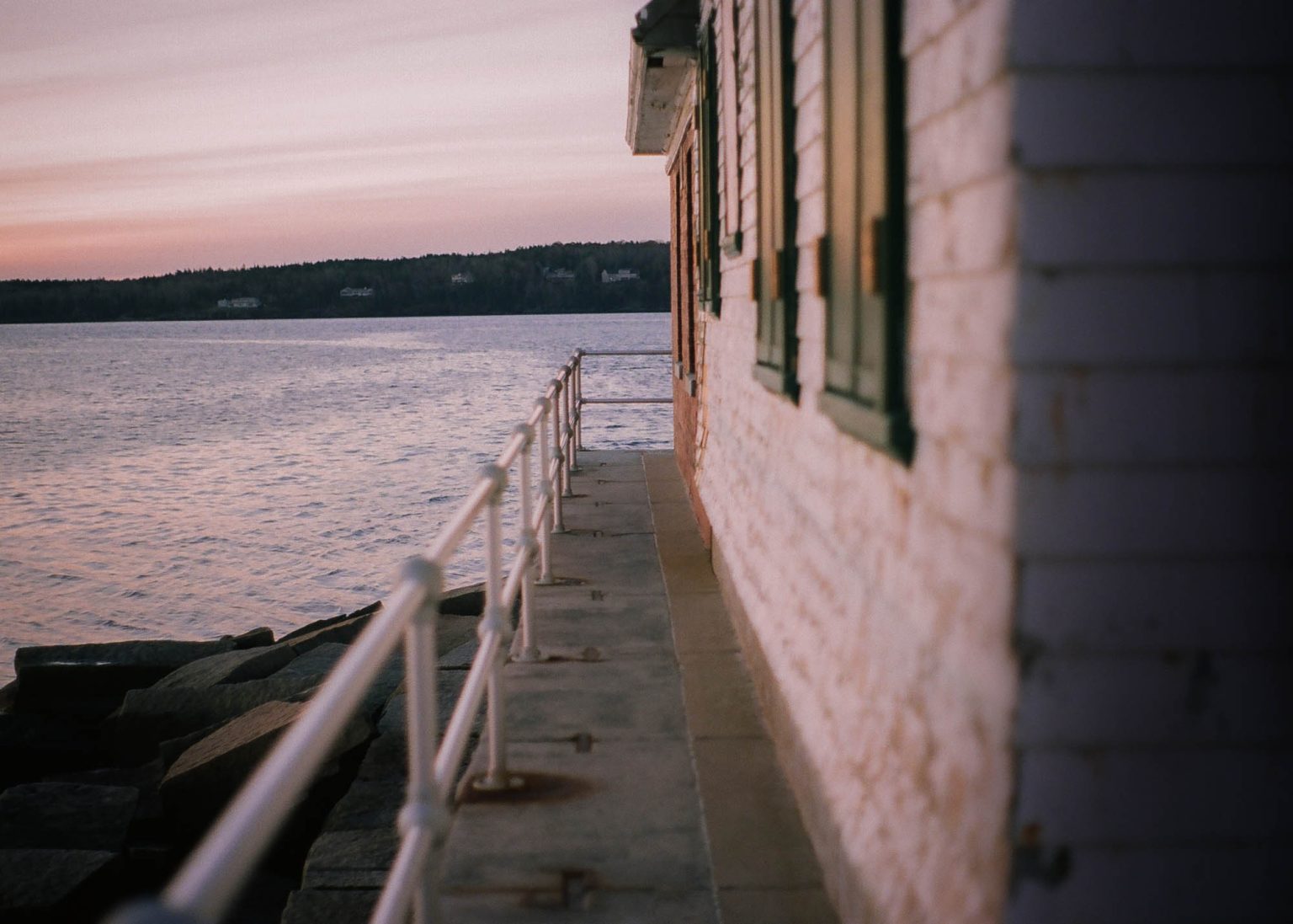 Side of the Breakwater lighthouse at sunrise in Rockland, Maine